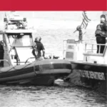 Two Seattle Fire Department boats are on the water, with personnel on board.