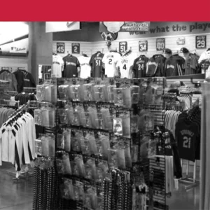 "Black and white photo of a sports merchandise store with jerseys and accessories"