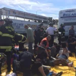 First responders treat injured passengers on a yellow tarp at the "Ride the Ducks" crash scene.