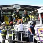 Firefighters and first responders at the scene of a devastating crash involving a tour bus.