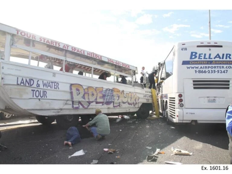 The aftermath of the "Ride the Ducks" and Bellair bus crash, with a person on the ground.