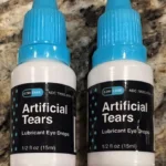 "Two bottles of EzriCare Artificial Tears lubricant eye drops on a counter"