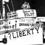 "Boat painted with protest messages about Native American rights and liberty"