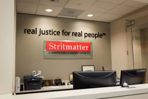 Reception area of the Stritmatter law firm, featuring the slogan 