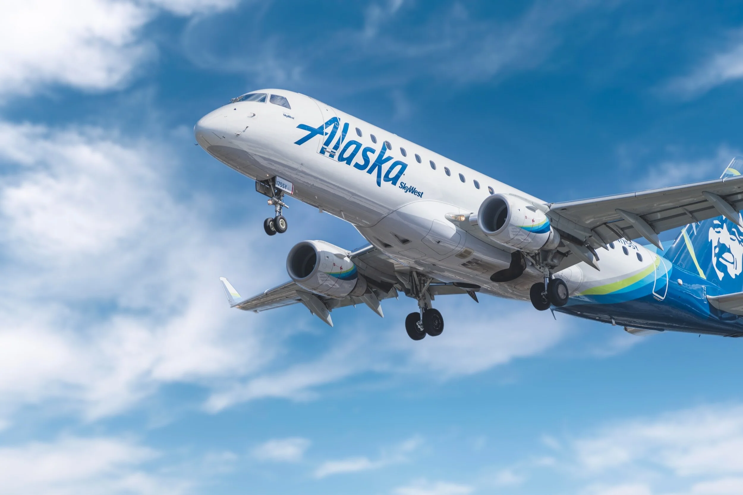 Alaska Airlines jet approaching landing with landing gear down.
