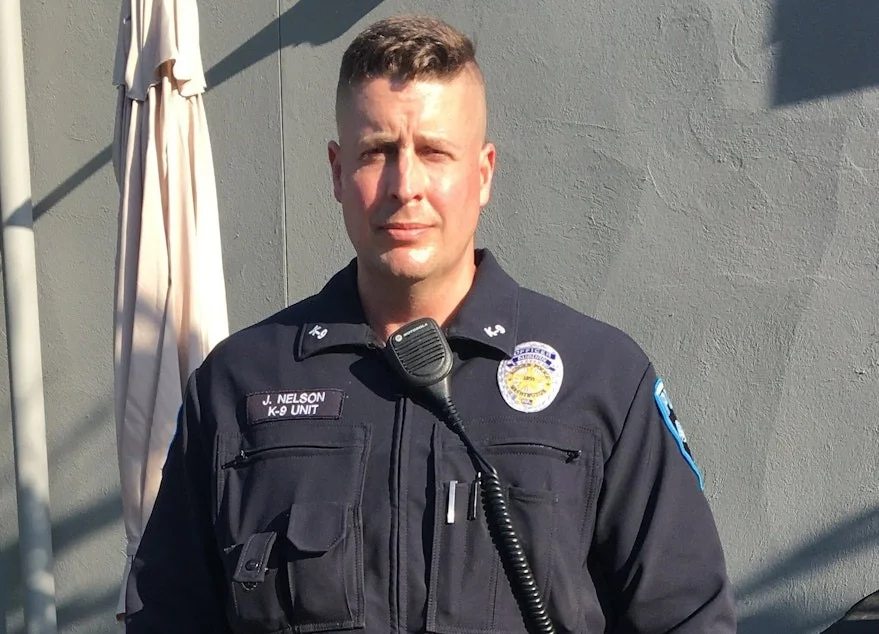 A headshot of police officer J. Nelson of the K-9 Unit in his uniform.