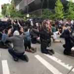 This image shows a protest scene in an urban area: