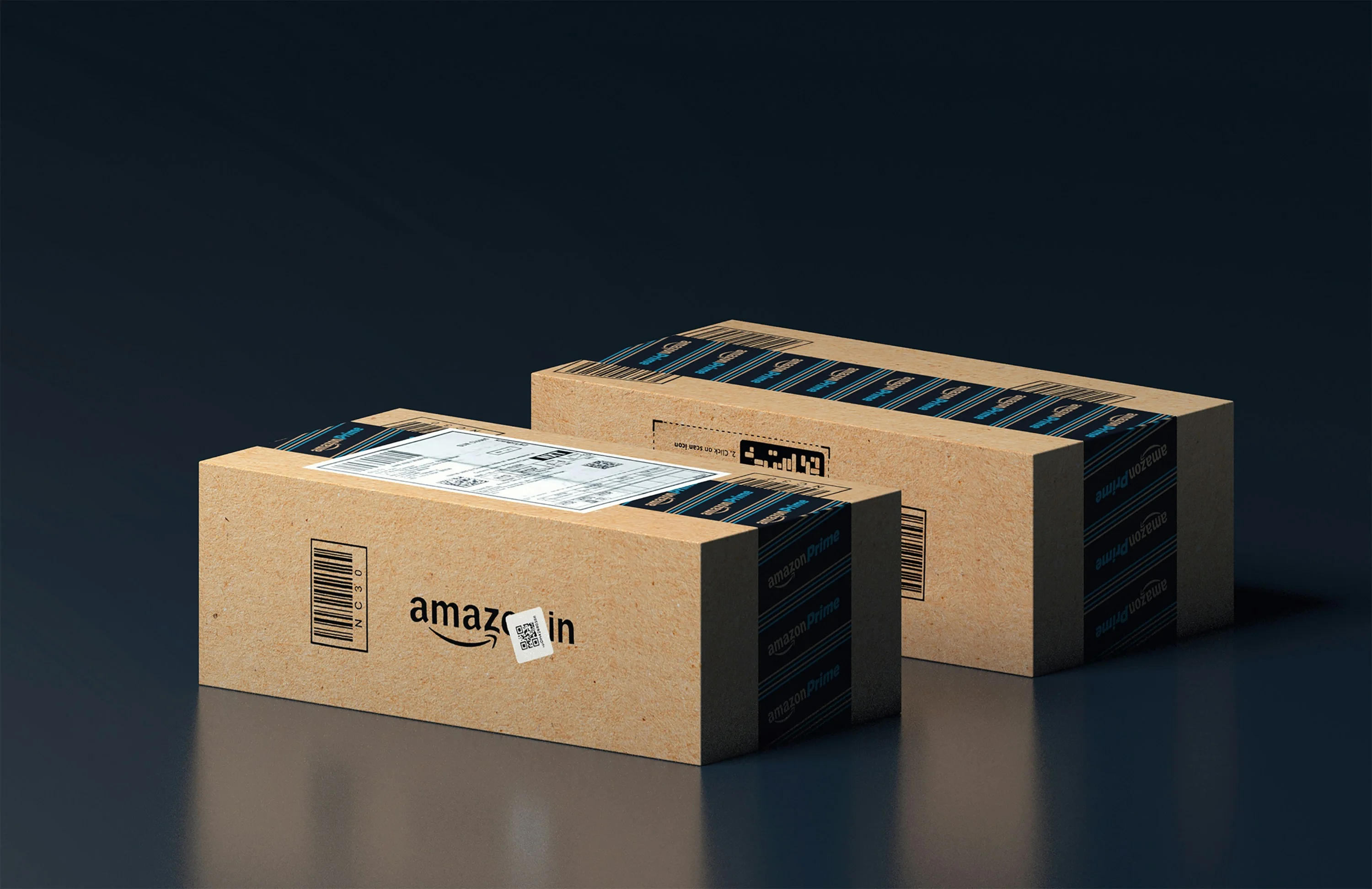 Two rectangular Amazon Prime cardboard packages sealed with black and blue Amazon Prime-branded tape, placed on a dark reflective surface with visible shipping labels and barcodes.