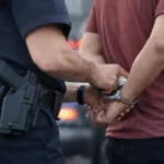 Police officer placing handcuffs on a person during a domestic disturbance call