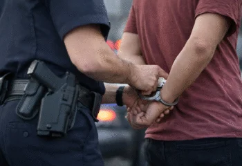 Police officer placing handcuffs on a person during a domestic disturbance call