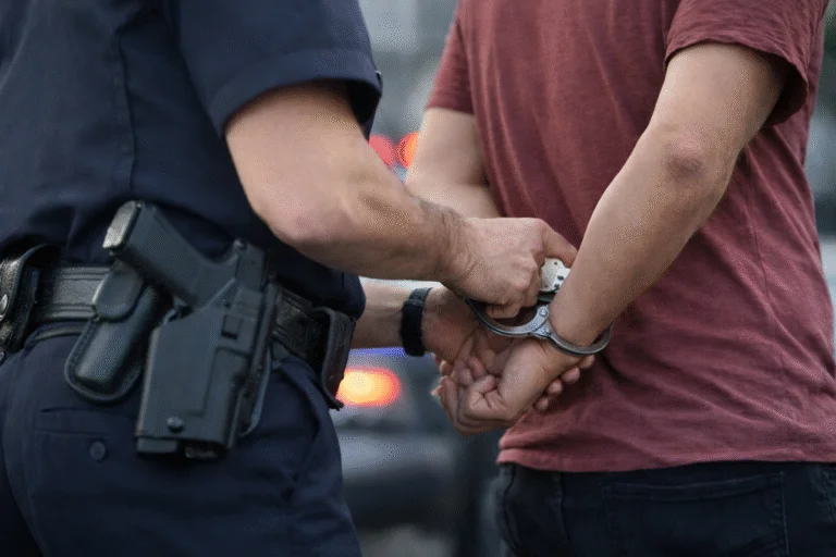 Police officer placing handcuffs on a person during a domestic disturbance call
